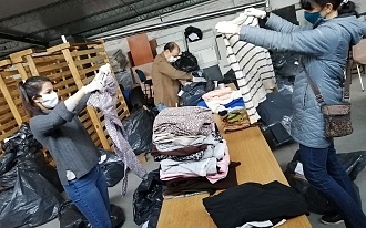 Voluntarios colaboran en clasificación de ropa para niños - 1